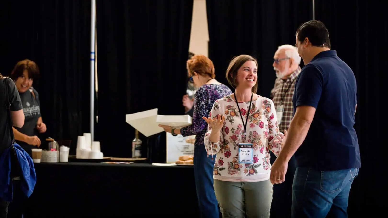 Group-of-individuals-speaking-at-booth